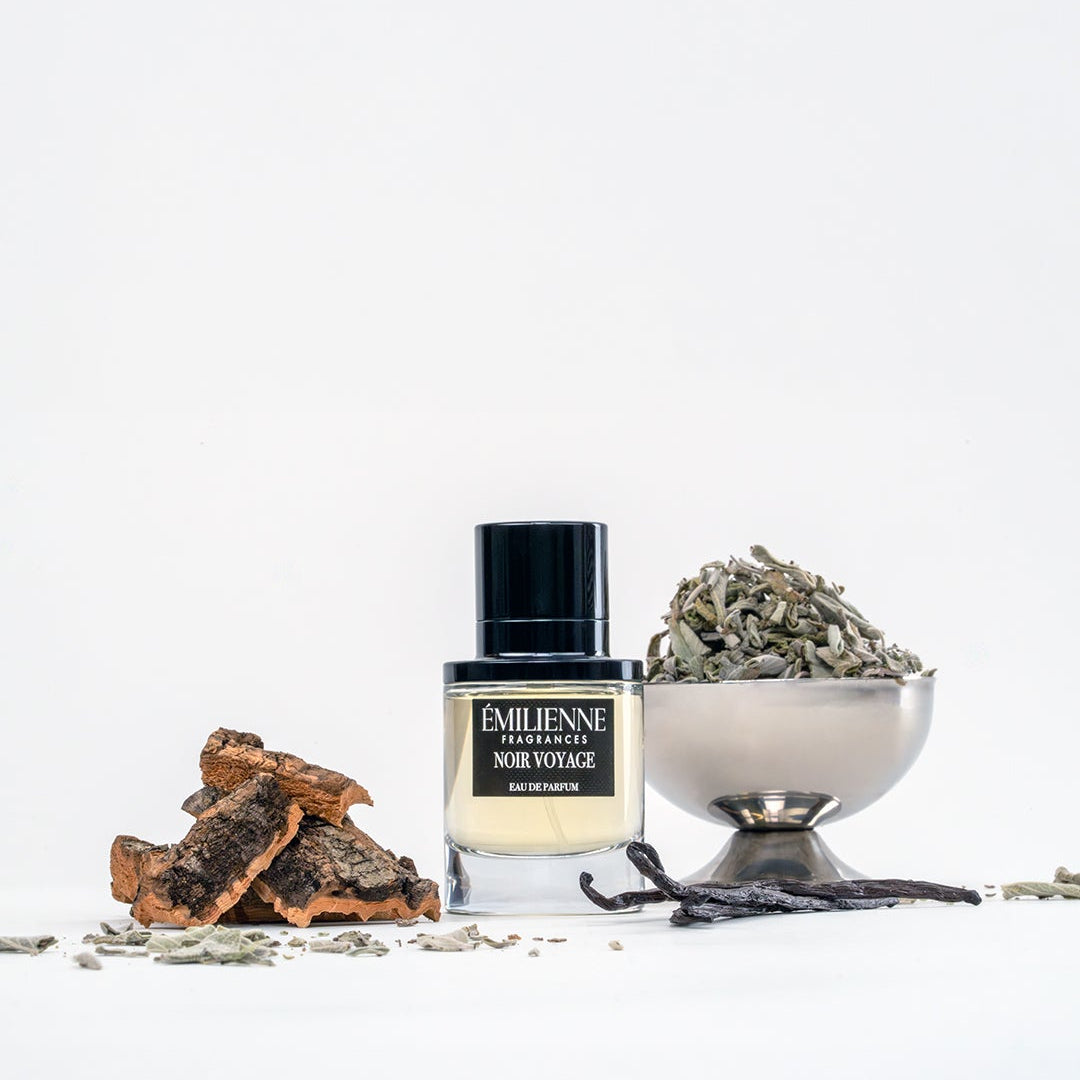 Perfume bottle with dried herbs and a bowl on a white background